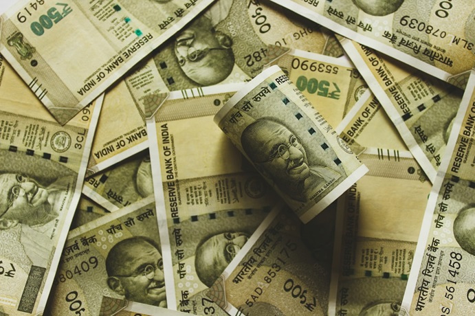 Indian rupee notes of 500 spread on a surface.